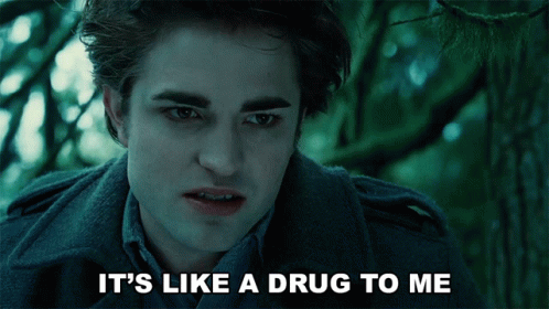 The image shows a scene from the movie Twilight featuring Edward Cullen, played by Robert Pattinson. Edward has a serious expression, and the caption reads, "It's like a drug to me," referencing his strong feelings for Bella, the main character.